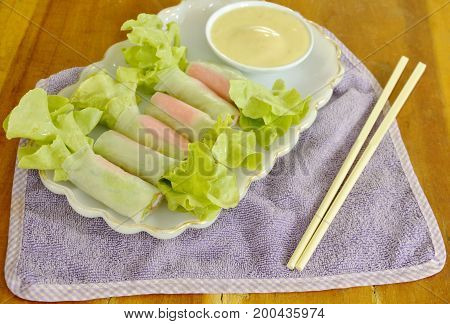 imitation crab stick and green oak wrapped flour paste dipping cream sauce on plate