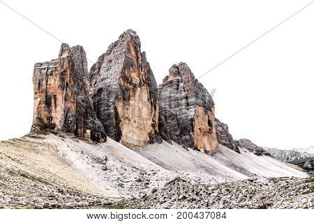 The three peaks of Lavaredo ( Italian: Tre Cime di Lavaredo) in the italian Dolomites isolated by a white cloudy sky