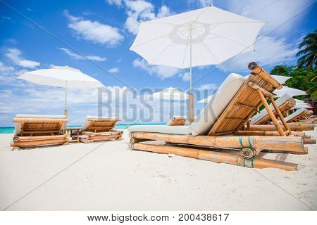 Beach chairs on exotic tropical white sandy beach