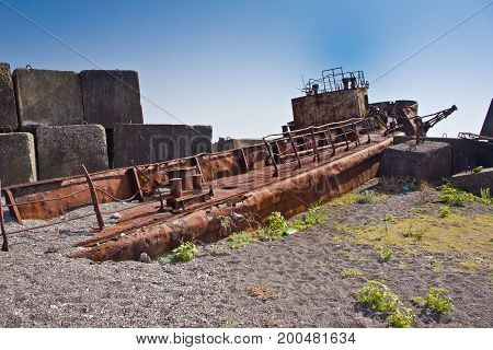 Rusty abandoned shipwreck on the beach in Sukhum, Abkhazia, Georgia