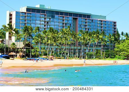 August 1, 2017 at Lihue in Kauai, HI:  Marriott Hotel Resort Kalapaki Bay surrounded by Palm Trees and a sandy beach where guests can sunbathe on the sandy beach or swim and surf in the ocean taken at Lihue in Kauai, HI