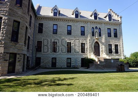 JOLIET, ILLINOIS / UNITED STATES - JULY 18, 2017: A stairway leads to an entrance of the historic Welcome Center, at the University of Saint Francis.