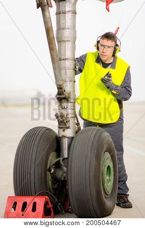 airport worker mechanic service maintenance chassis tire
