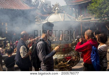 Taipei Taiwan - March 20 2015: Buddhists praying in Longshan temple