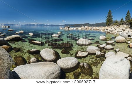 Beautiful boulders and crystal clear water of the lake Tahoe. Hidden Beach, Lake Tahoe - Nevada, USA. Panorama