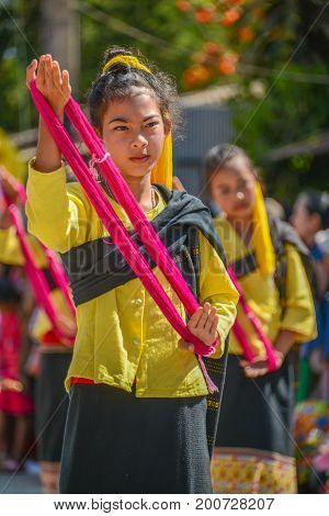 CHIANGMAI THAILAND - JANUARY 25 2015: Indigenous little girls with traditional costume dancing in traditional style in parade of 22nd Traditional Skirt Fabric and The Indigenous Product and Culture Festival in Mae Chaem Chiangmai Thailand