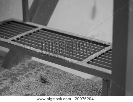 BLACK AND WHITE PHOTO OF CLOSEUP METAL STAIR FLIGHT