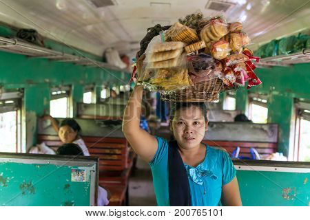 Mandalay, Myanmar - October 4, 2016: Unidentified burmese woman selling snaÃÂks in the train between Mandalay and Hsipaw in Myanmar