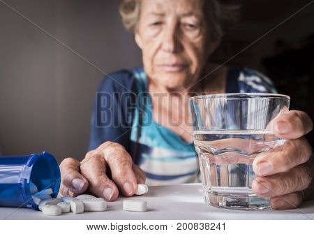 Oldster taking daily medication dose at home, Andalusia, Spain