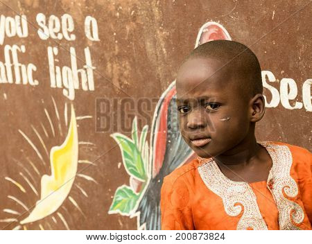 Ghana - December 28 2016: African Ghana child playing on the street