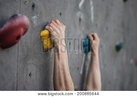 Close-up of asian male Climbing focus on hands