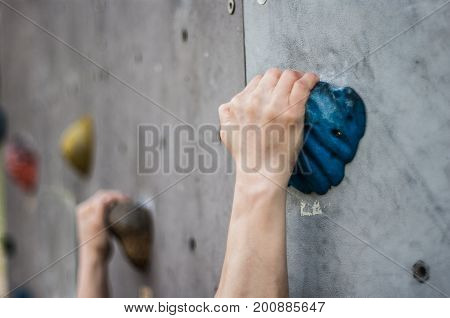 Close-up of asian male Climbing focus on hands