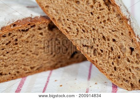 Sliced homemade rye bread on a traditional cloth