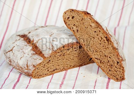 Sliced homemade rye bread on a traditional cloth
