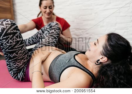 Doula showing labor positions to a pregnant woman