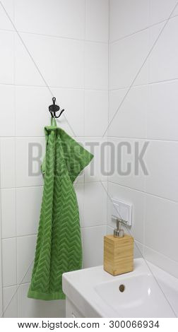 Bathroom Interior In Light Colors With Sink, Bamboo Soap Dispenser And Green Towel