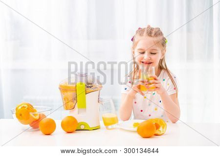 Braided girl enojoying morning glass of orange juice