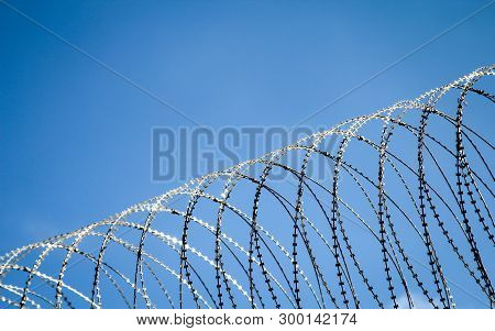 Barbed Wire On A Fence Of A Prison To Prevent Unauthorized Access