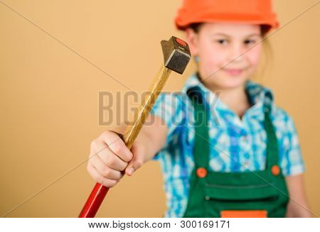 Hammer In Hand Of Small Girl Repairing In Workshop. Foreman Inspector. Little Girl In Helmet With Ha