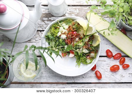 Salad With Chicory, Rapunzel, Tomatoes, Radish. A Green, Healthy Vegetarian Diet.
