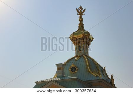 Double-headed Eagle Symbol Of Russian Federation On Top Of Golden Dome. Gilded Cupola On Historic Bu