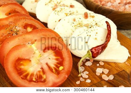 Fresh Mozzarella Cheese And Tomatoes Onkitchen Cutting Board. Healthy Diet Food. Chili Peppers With 