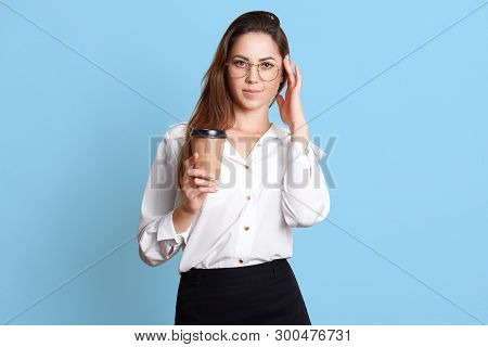 Adorable Businesswoman In White Blouse And Black Skirt With Coffee Or Tea In Paper Cup, Has Headache