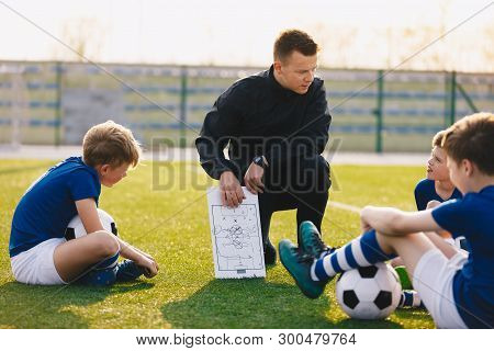 Football Coach Coaching Children. Soccer Football Training Session For Children. Young Coach Teachin