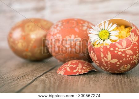 Easter Eggs And Margarita Flower On Wooden Table, Shallow Dof, Focus On The Flower Petals And Part O
