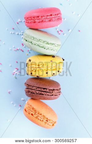 Colorful French Macarons On Blue Background Traditioanal Dessert In France,vertical