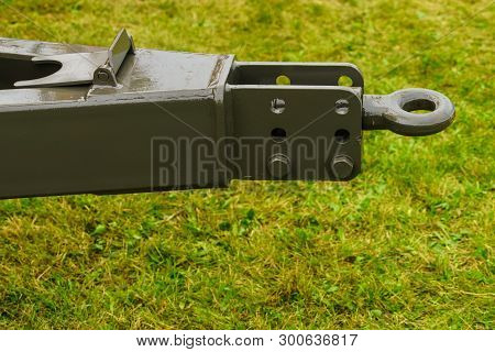 Close Up On Dark Towbar In Agricultural Machine Vehicle. Green Grass In Backround.