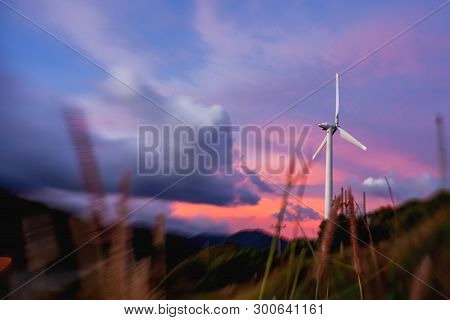 Gorgeous Sunset On Kata Beach View Point. Electric Wind Turbine On Pink Cloudscape Background. Phuke