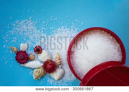 Sea Salt In Bottle On Blue Background, Sea Shells And Flowers