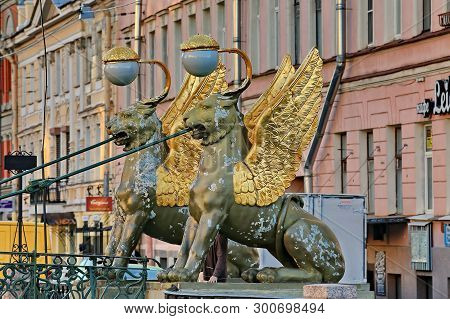 St. Petersburg, Russia - 05/16/2019: Gilded Wings Of Griffin Statues. Bank Bridge Is A 25-m-long Ped