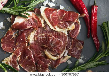 Hamon.tasty Ham Sliced ​​into Strips On A Wooden Background With Spices And Fresh Thyme. A Serving O