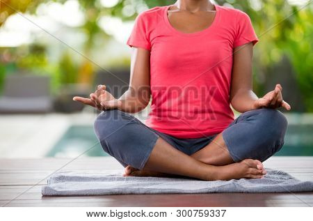 Yoga meditation in lotus pose, female doing yoga in nature