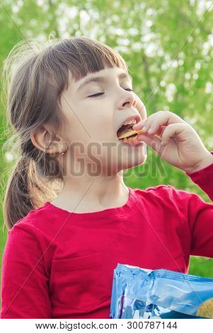 Child Eats Chips. Selective Focus. Food And Drink.