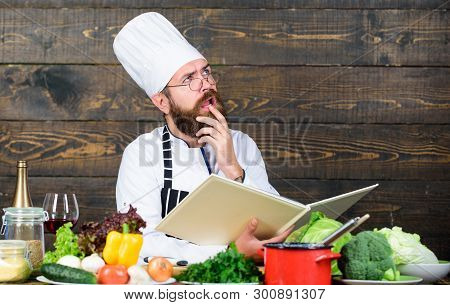 Man Bearded Chef Cooking Food. Guy Read Book Recipes. Culinary Arts Concept. Man Learn Recipe. Try S