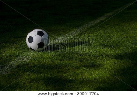 Black And White Soccer Ball On Green Soccer Pitch