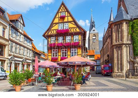 Quedlinburg, Germany - August 12, 2012: Town square and cafe near old house in Quedlinburg