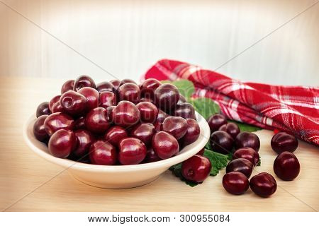 Fresh Ripe Sweet Cherry In A Plate On A Light Table