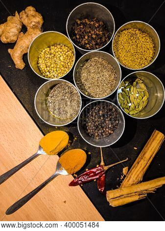 Closeup Of Different Variety Of Indian Spices Placed In A Top Angle View. Mustard . Dry Chilly. Cinn