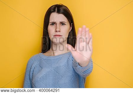 Confident Serious Millennial Young Female Showing Stop Gesture, Displeased Brunette Girl Look At Cam