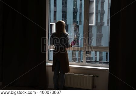 Smiling Black Woman Cleaning Windows With Glass Cleaner