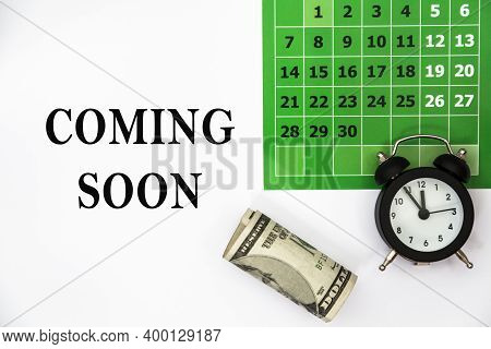 Coming Soon. Abstract Calendar Green Collour, Money And Watch. Business Concept Written On Notepad. 