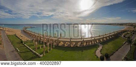 Aerial Panoramic View Across A Beautiful Landscaped Garden To The Sea In Tropical Resort With Large 