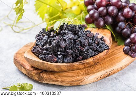 Black Raisins  In Bowl On Stone  Background, Table Top View. Dried Fruit, Healthy Snack Food. Dry Bl