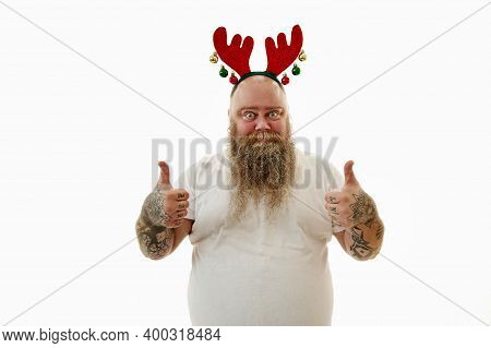 Portrait On A White Background Of An Overweigh Man With Tattooed Arms Wearing A Hoop With Antlers On