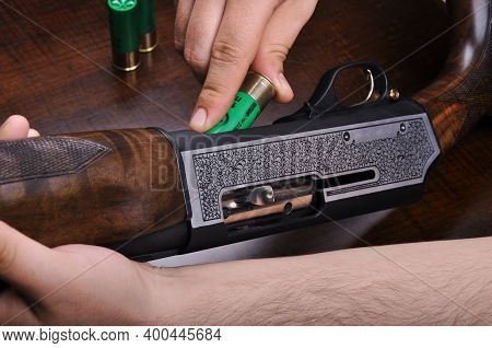 Shotgun Bullet And Trigger Mechanism Isolated On Wood Background, Hunting Shotgun Detail