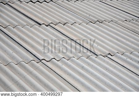 A Fragment Of A Gray Slate Roof Of An Old Sample Made Of Asbestos Material